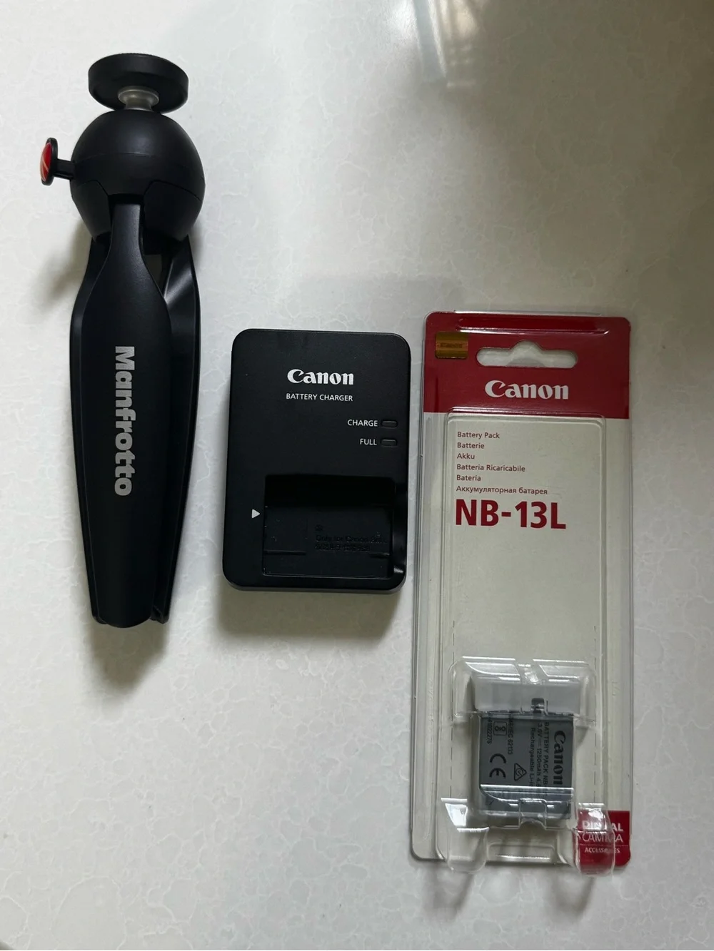 Canon NB-13L Battery Pack, Canon Charger, and Manfrotto Black Tripod